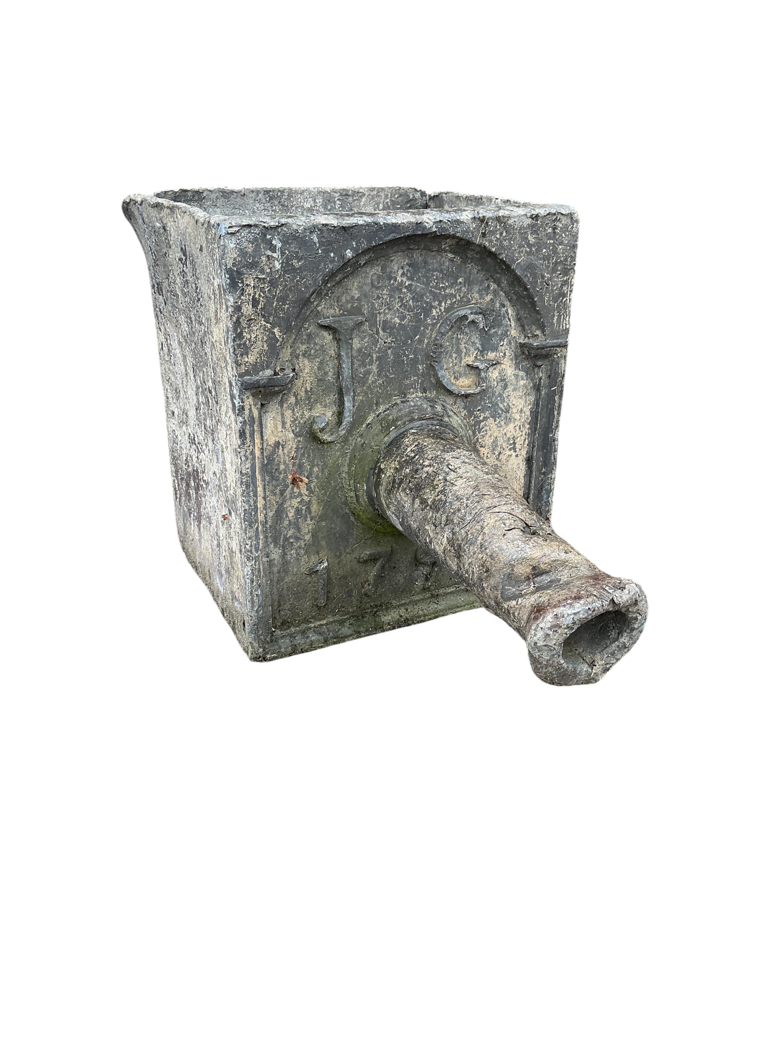 A George III lead hopper dated 1799 and initialled J.G., width 26cm, depth 40cm, height 30cm